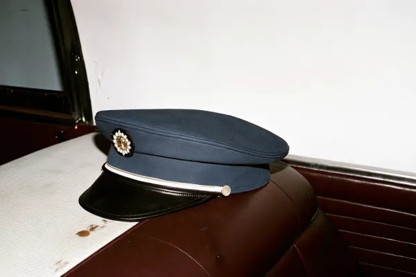 1990s---chauffeur-s-cap-on-leather-seat.jpg